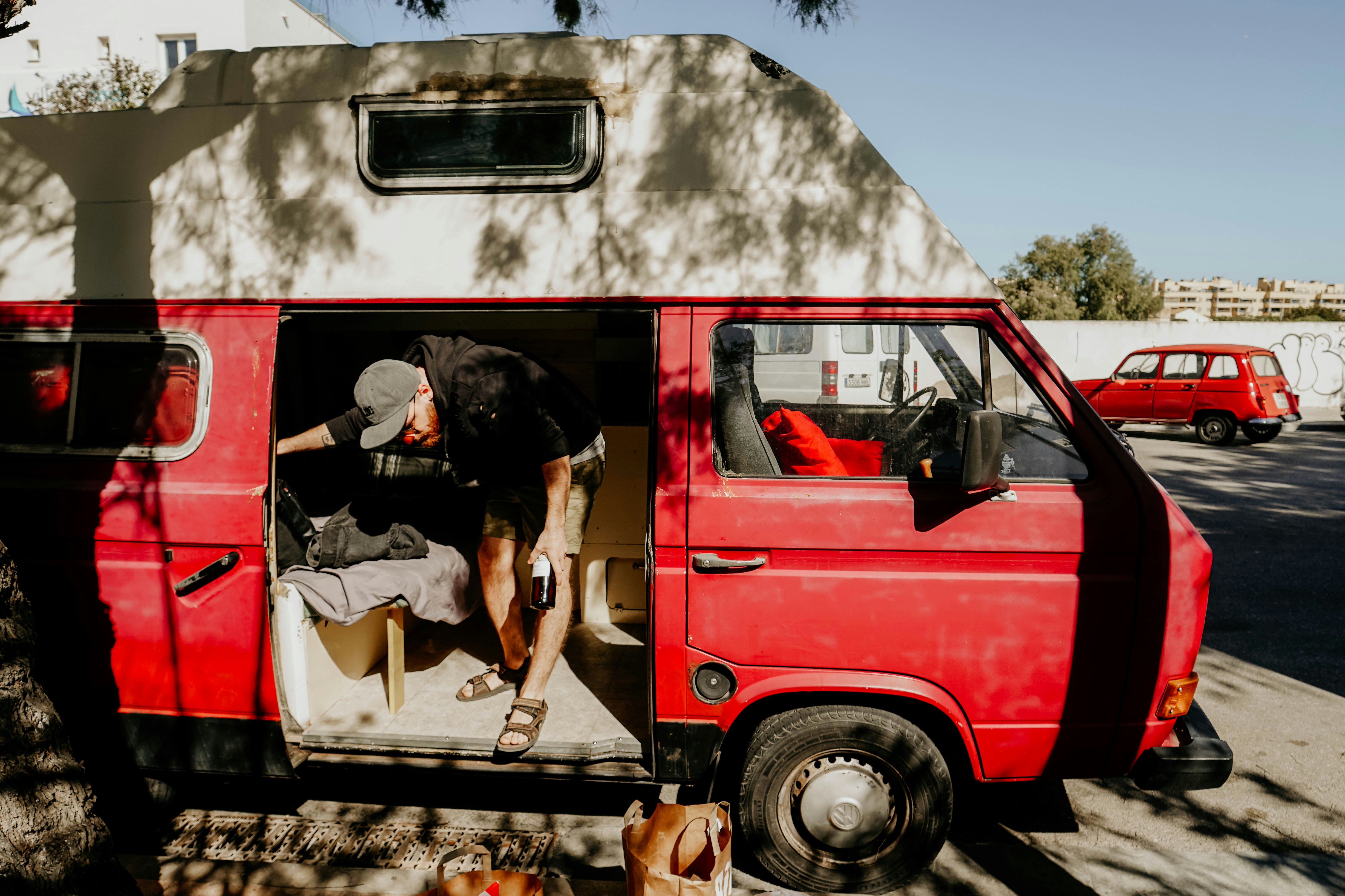 man standing inside van during daytime